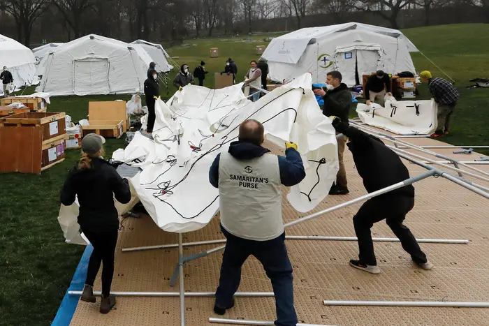 Volunteers with Samaritan's Purse erect a makeshift hospital in the East Meadow of Central Park on Sunday
